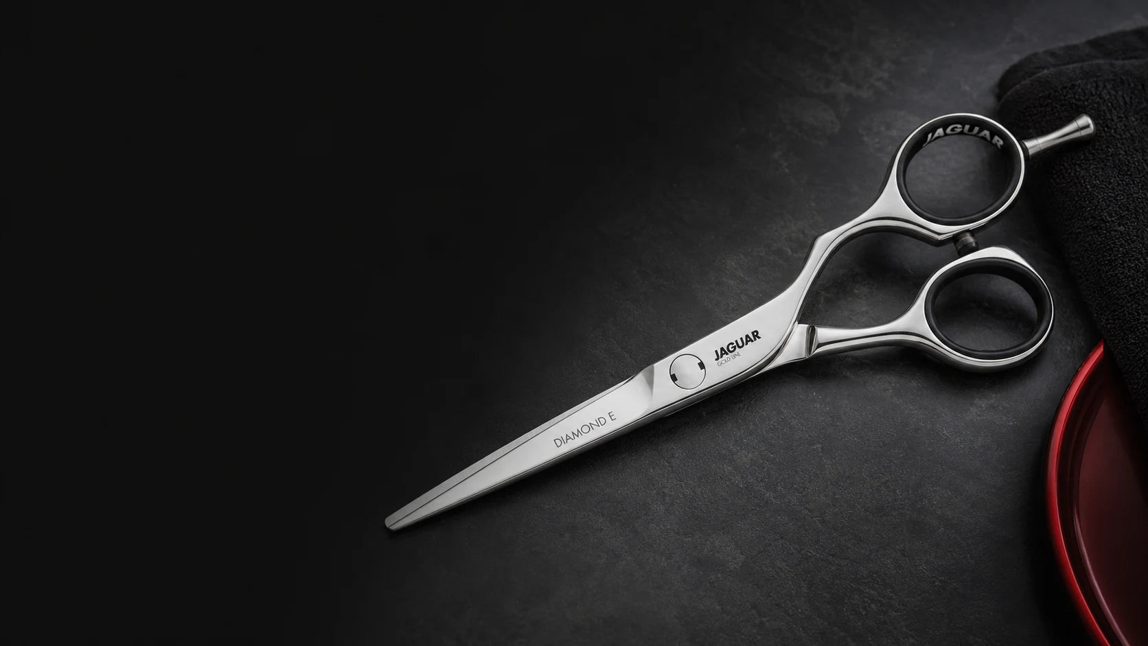 Jaguar hairdressing scissors on a dark work surface at Skarpast
